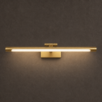 Akia brass wall light, switched on, with a warm glow